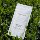 Senchaism Summer Breeze tea package on a green leaf background
