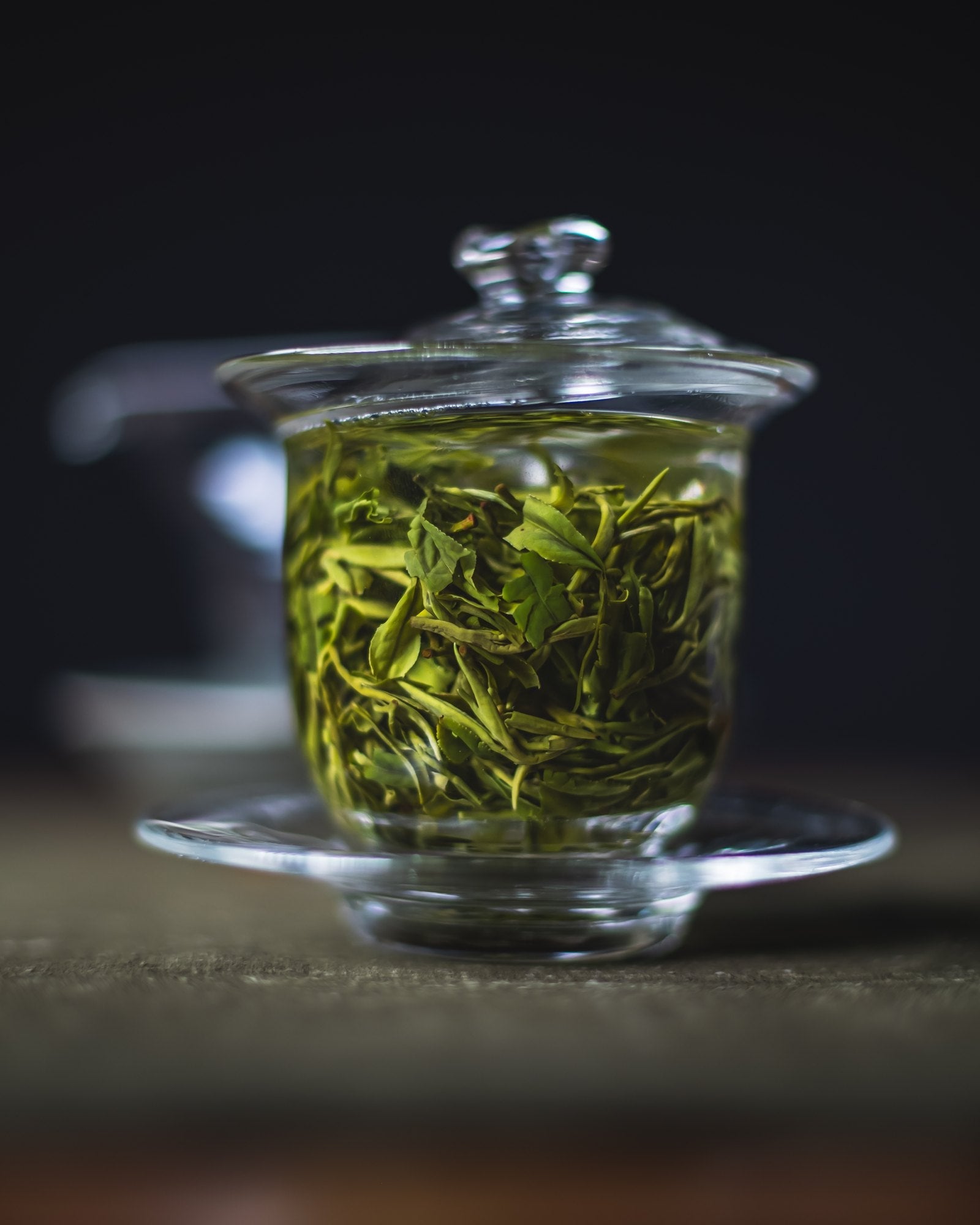 Saemidori green tea leaves unfurling in a glass — UNEARTHED Gallery München