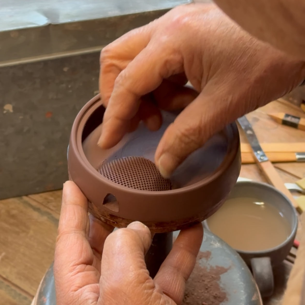 Seiji Ito attaching Ceramesh filter to Hira Kyusu teapot body.