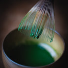 Chiyomukashi Matcha, bamboo whisk lifted from the wood-glazed bowl